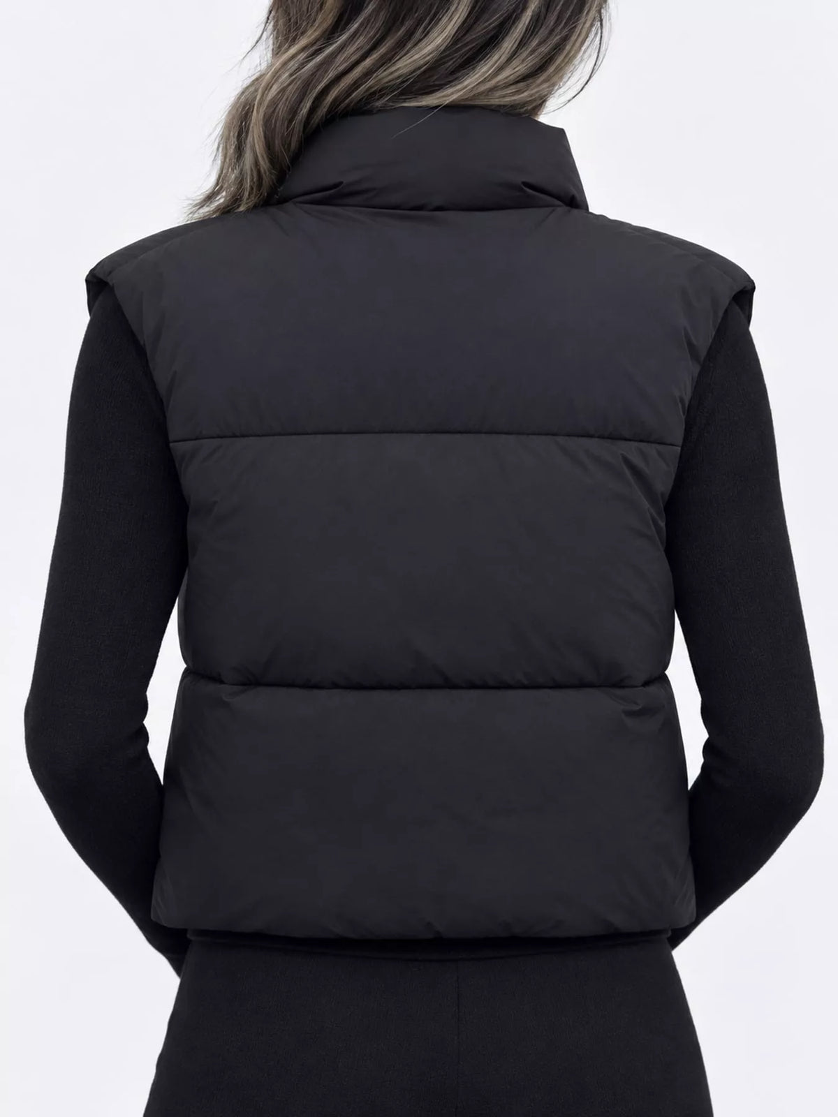 Black back view zip-up puffer vest with stand collar and quilted padding