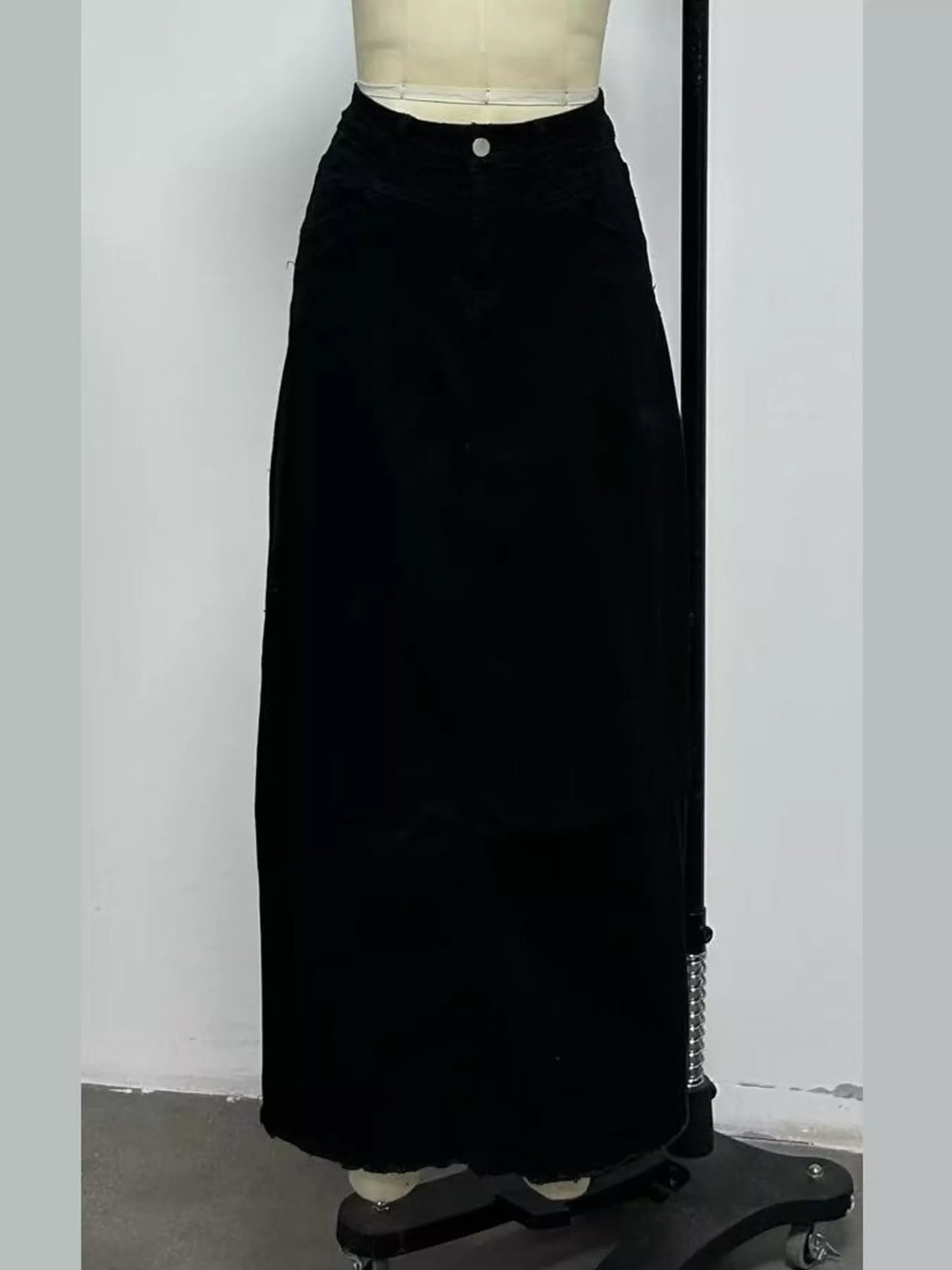 Black denim maxi skirt back view with waistband button and full length