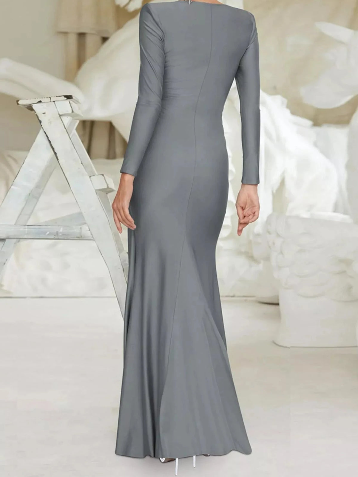 Twisted long-sleeve maxi dress in gray with draped knot waist and fitted silhouette