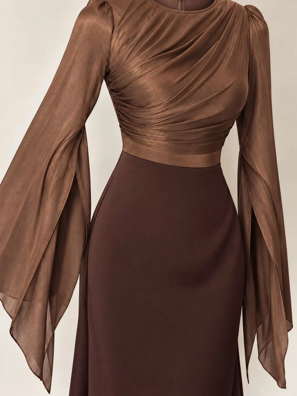 Close-up of the two-tone dress's ruched brown bodice and sheer flared sleeves