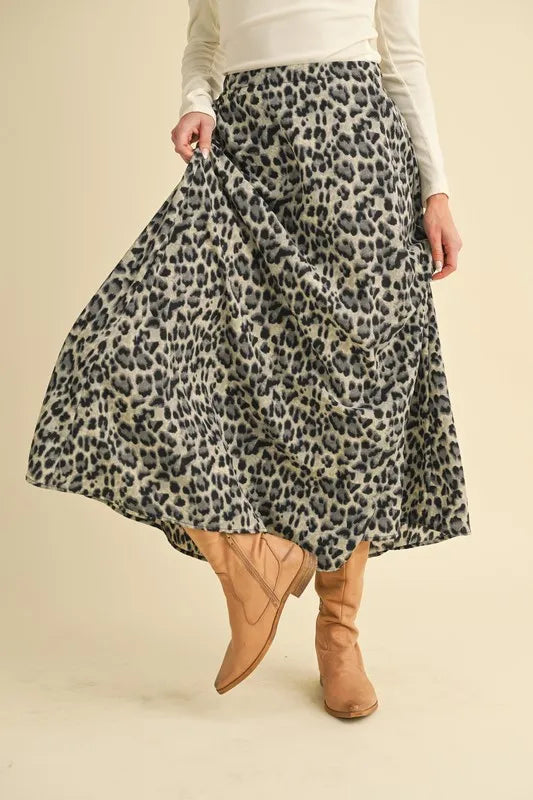 Aemi+Co leopard midi skirt shown lifted to reveal its flowing drape