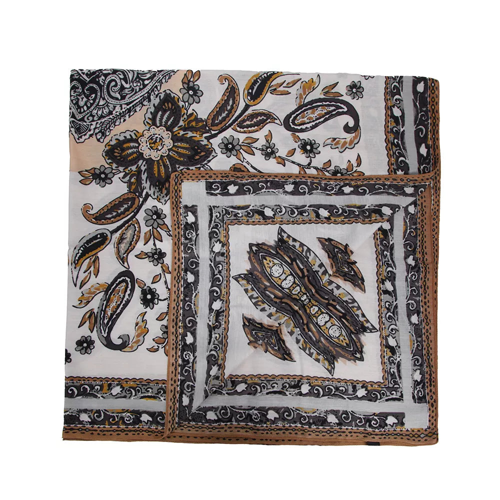 Square silk-feel scarf laid flat, showing gray, black and ochre paisley motifs and a bordered center.