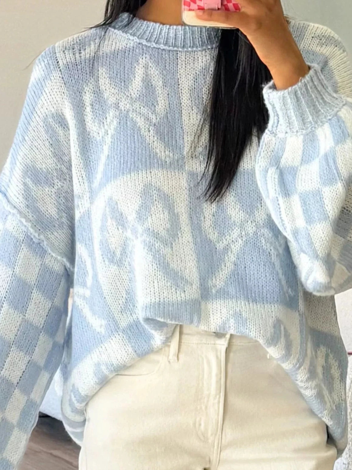 Light blue knit sweater with white check bow pattern and ribbed collar