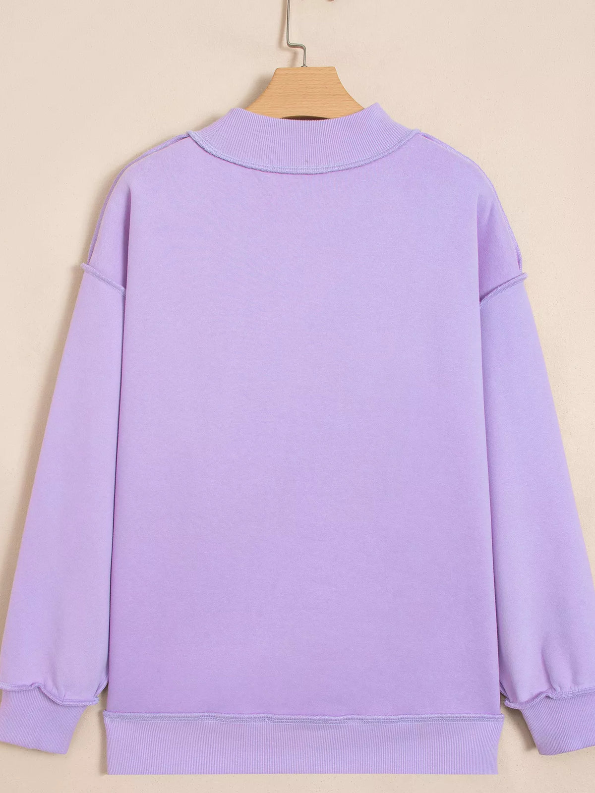 Lavender mock-neck sweatshirt back view on hanger, relaxed fit