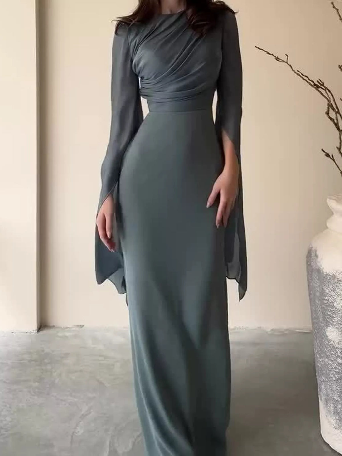 Dark gray maxi dress with a fitted waist and floor-length skirt
