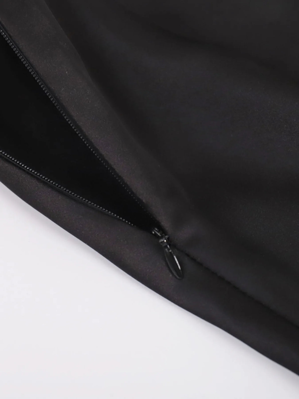 Close-up of black side zipper on high-waisted maxi skirt