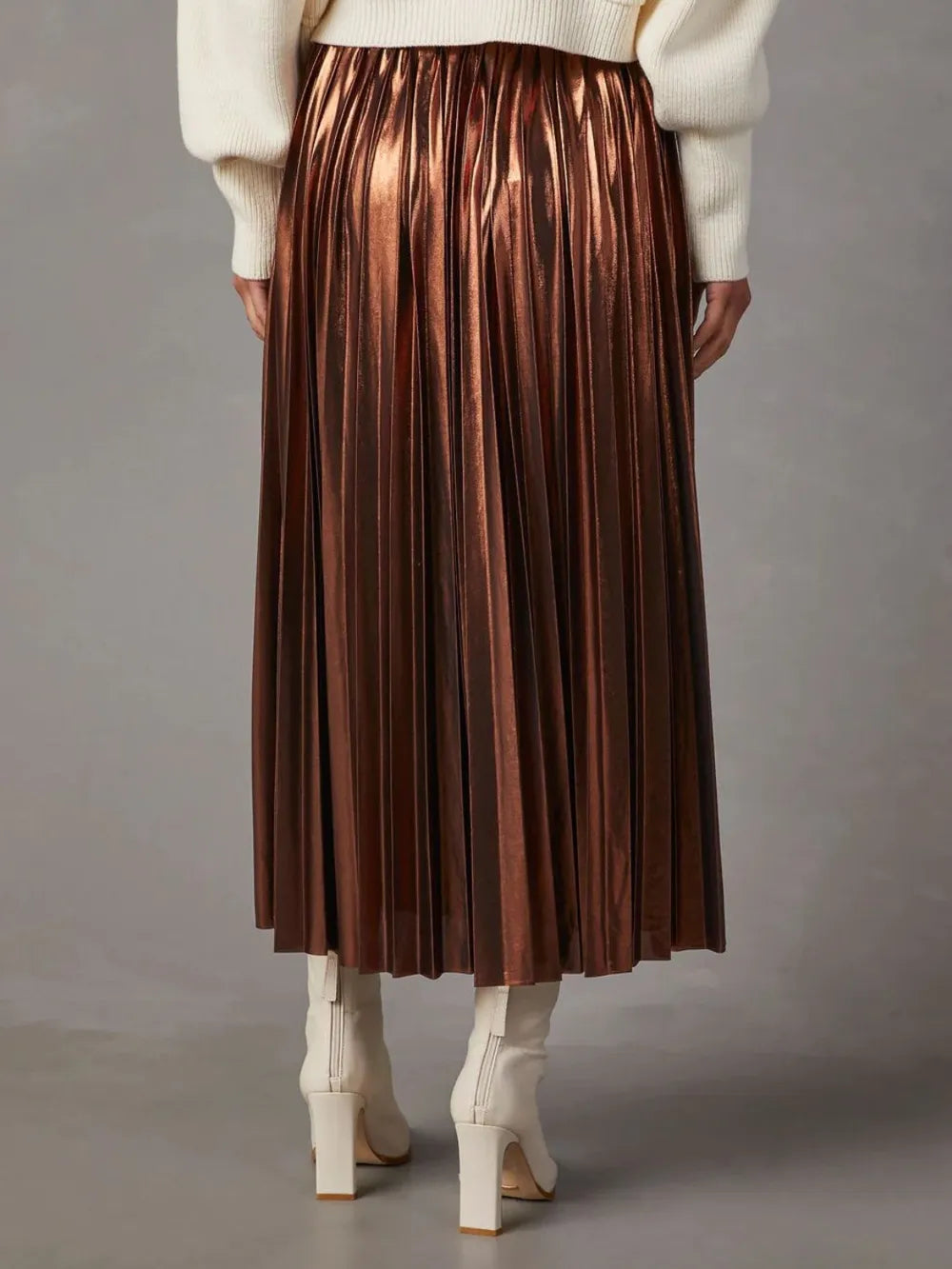 Back view of a glossy brown pleated midi skirt