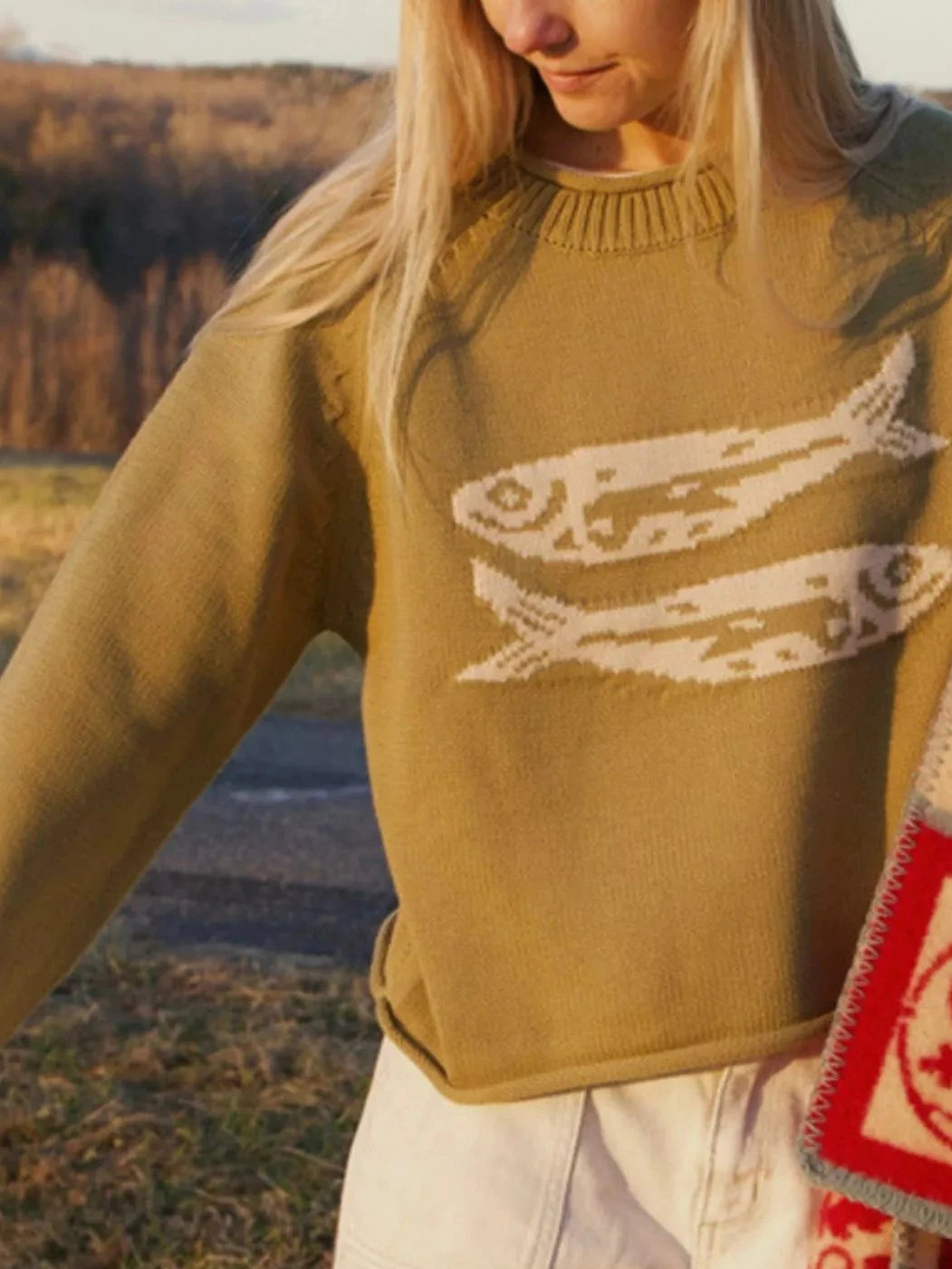 Tan crew neck knit sweater with white fish graphic across chest