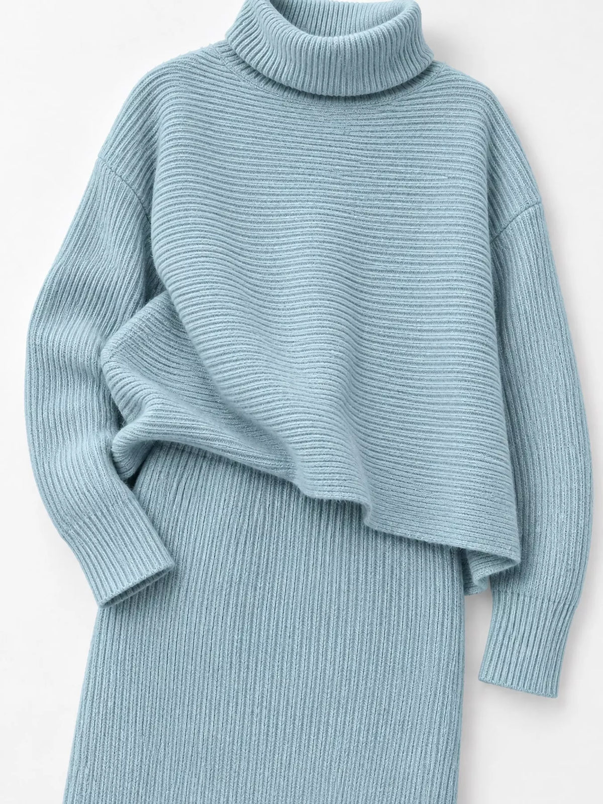 Close view of the light blue set's ribbed turtleneck sweater and matching midi skirt