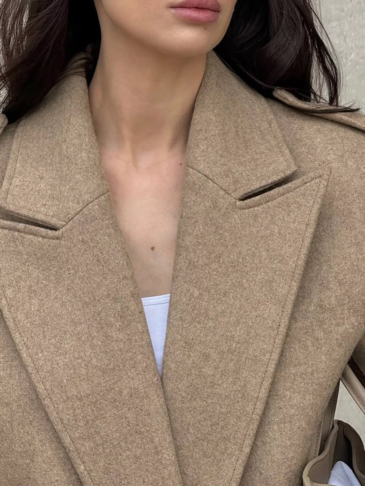 Brown cropped blazer detail with wide notched lapels and shoulder epaulettes
