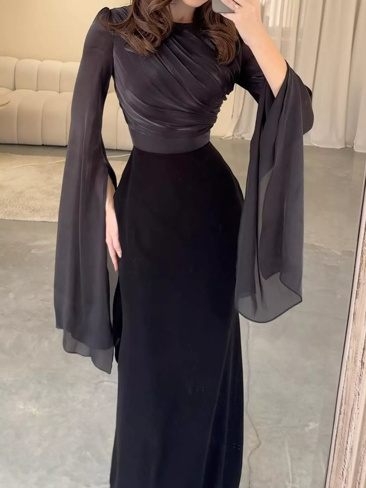 Black maxi dress with a ruched bodice and long sheer flare sleeves