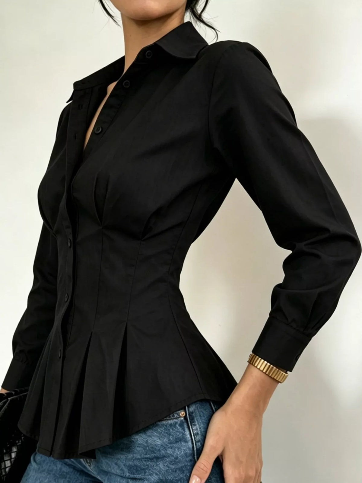 Black button-front peplum blouse with fitted waist and long sleeves