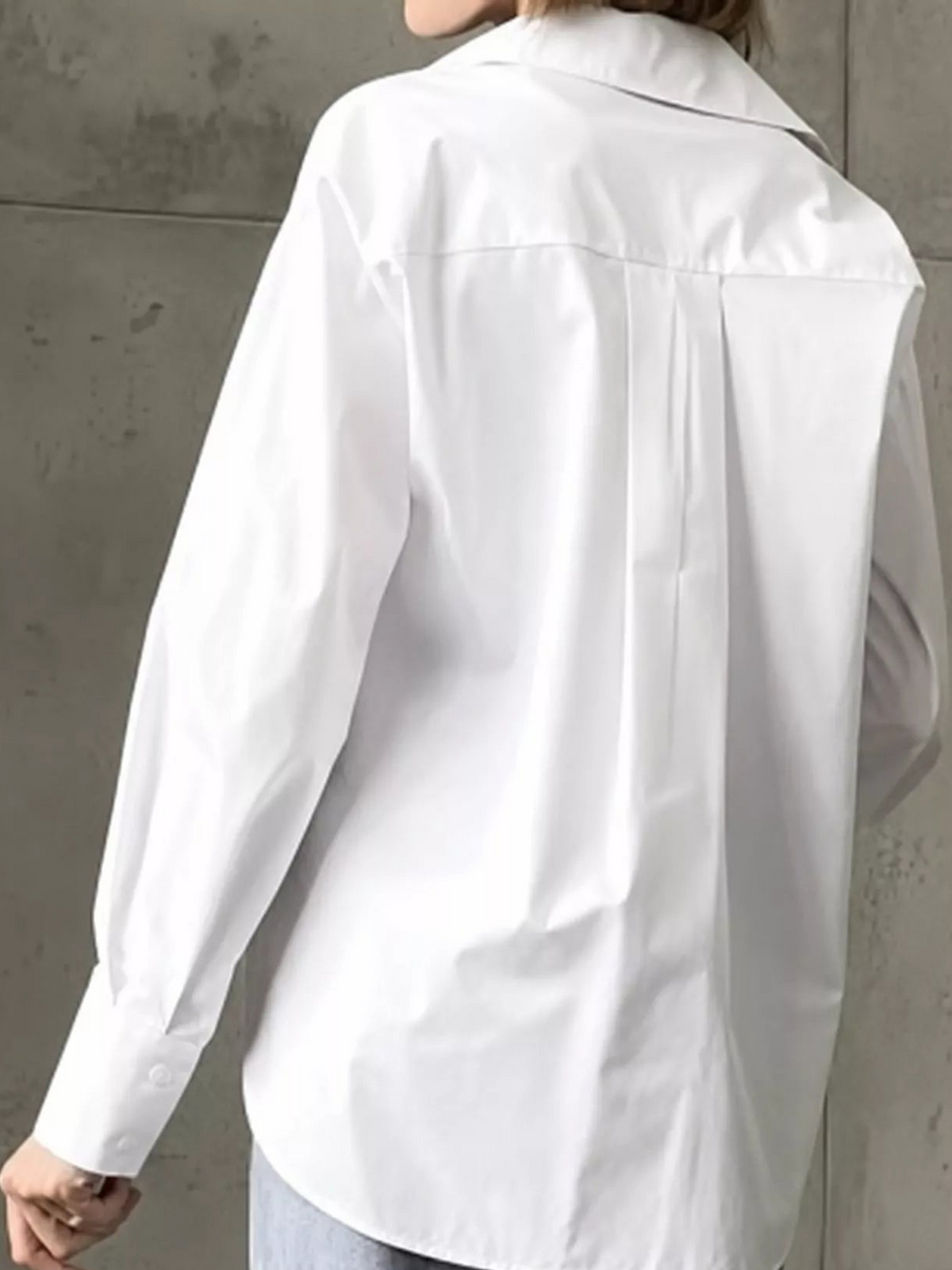 White button-up long sleeve shirt shown from back with back yoke and single patch pocket