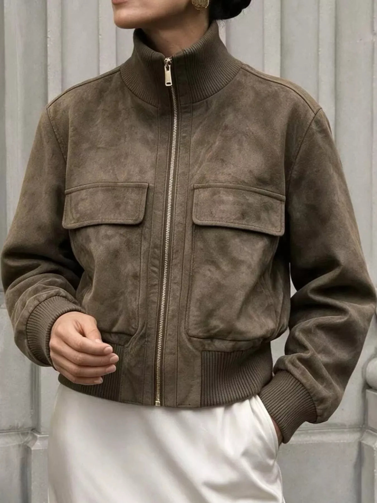 Olive-brown zip-up jacket with ribbed cuffs, stand collar, and two front flap pockets
