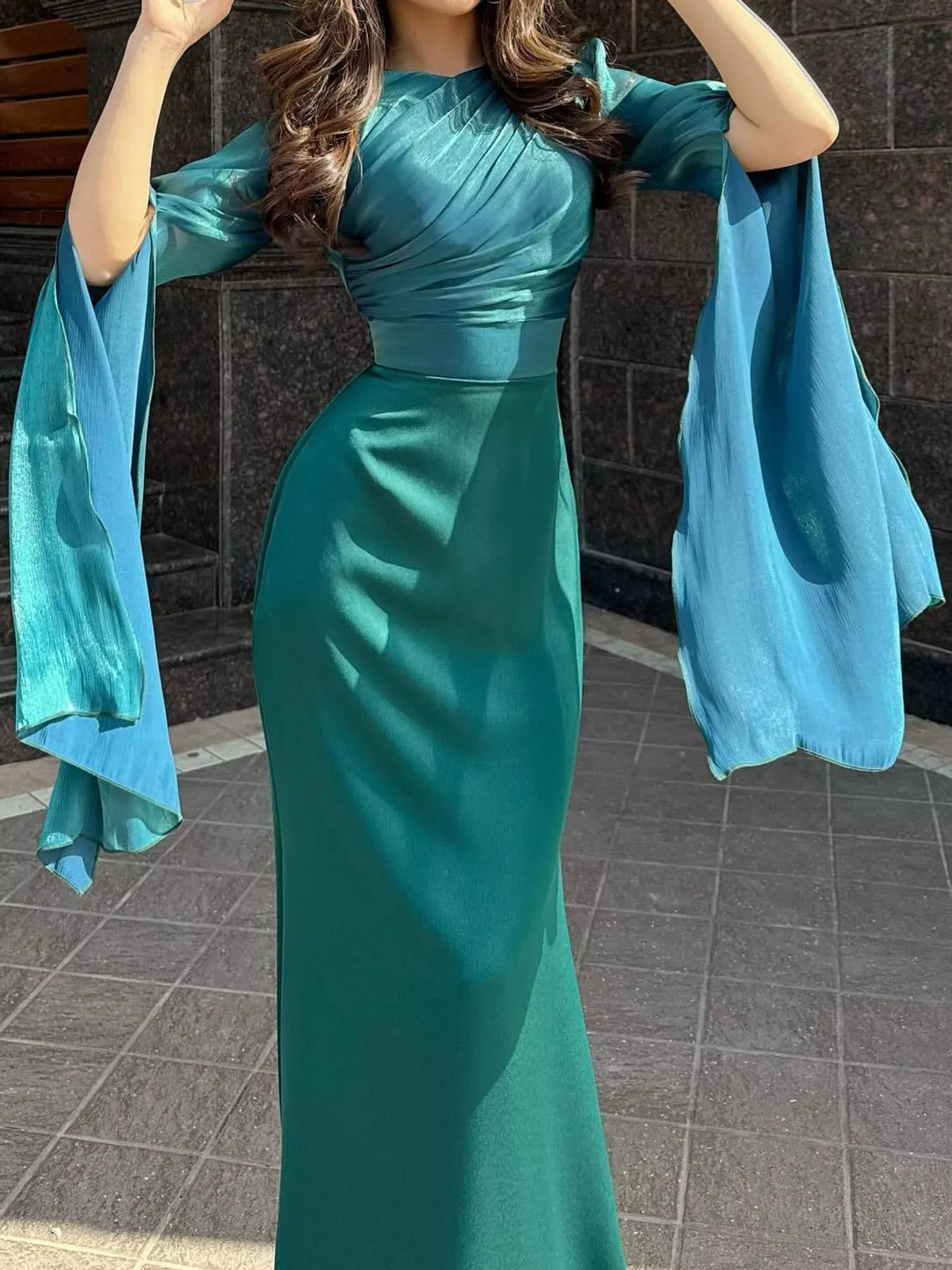 Teal maxi dress with a ruched bodice, fitted waist and flowing sheer sleeves
