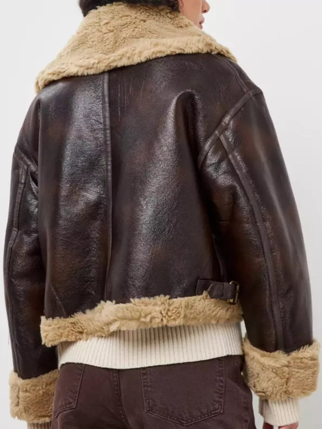Back view of dark coffee aviator jacket with shearling collar and hem, ribbed knit cuffs