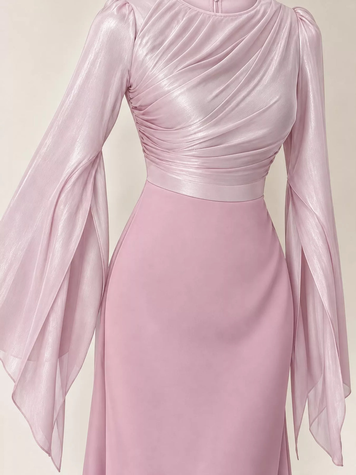 Pale pink maxi dress with a ruched bodice, fitted waist, and sheer flared sleeves