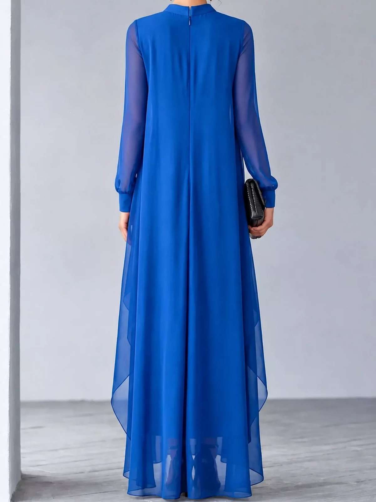 Back view of blue chiffon maxi dress with sheer sleeves and flowing layered hem