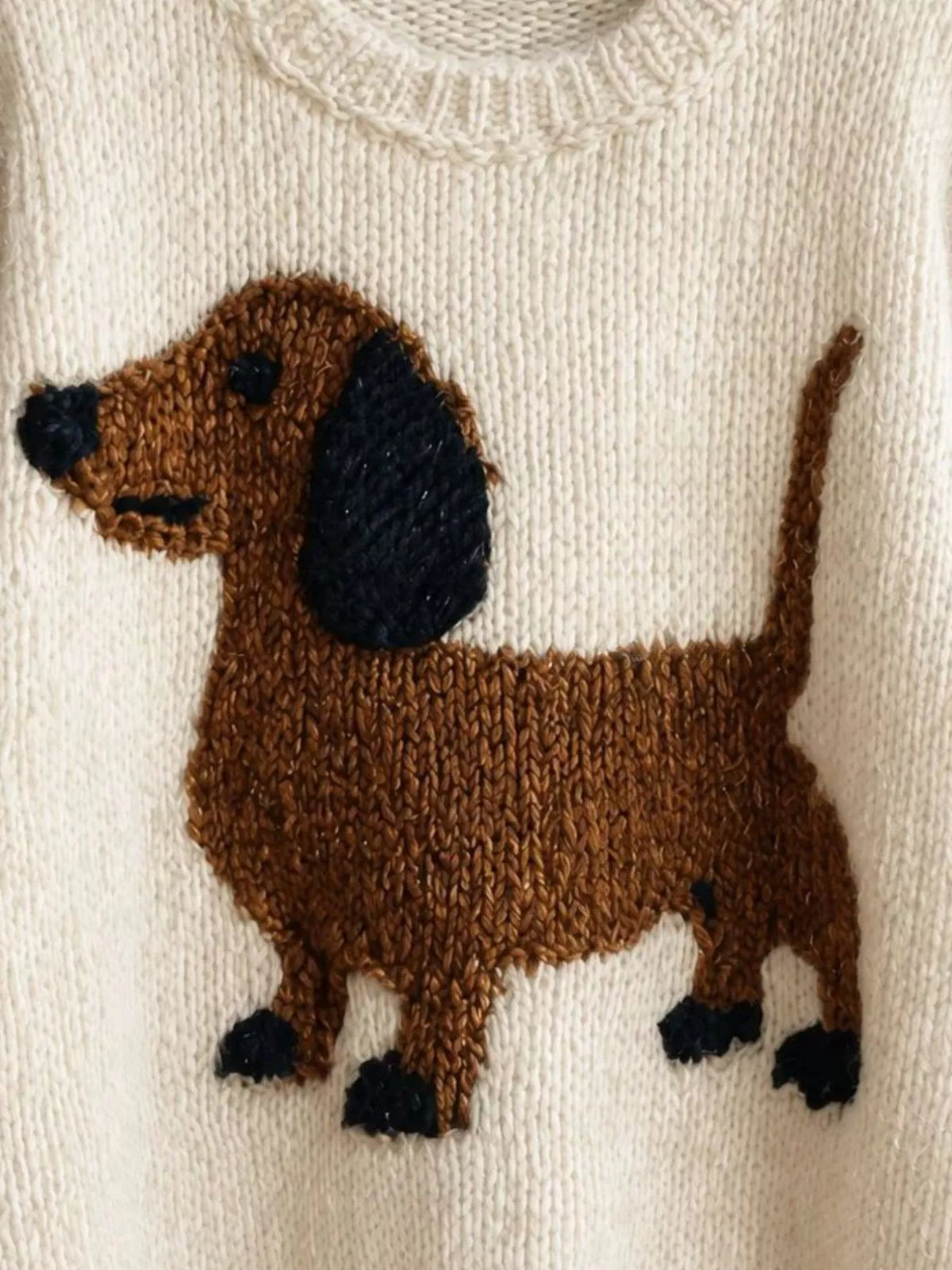 White dropped-shoulder knit sweater with dachshund intarsia front detail
