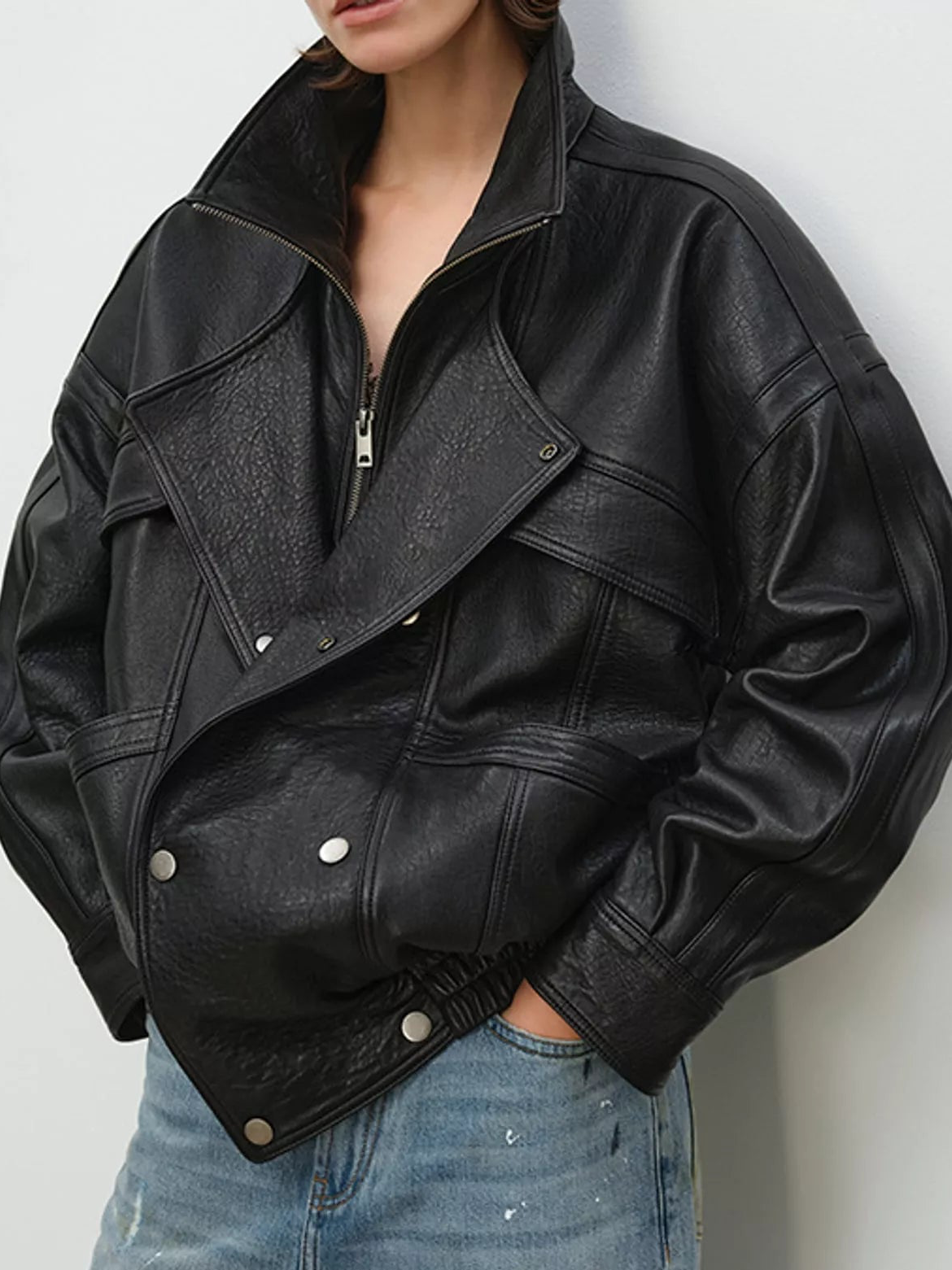 Black leather jacket with zip front and snap buttons, diagonal flap pocket detail