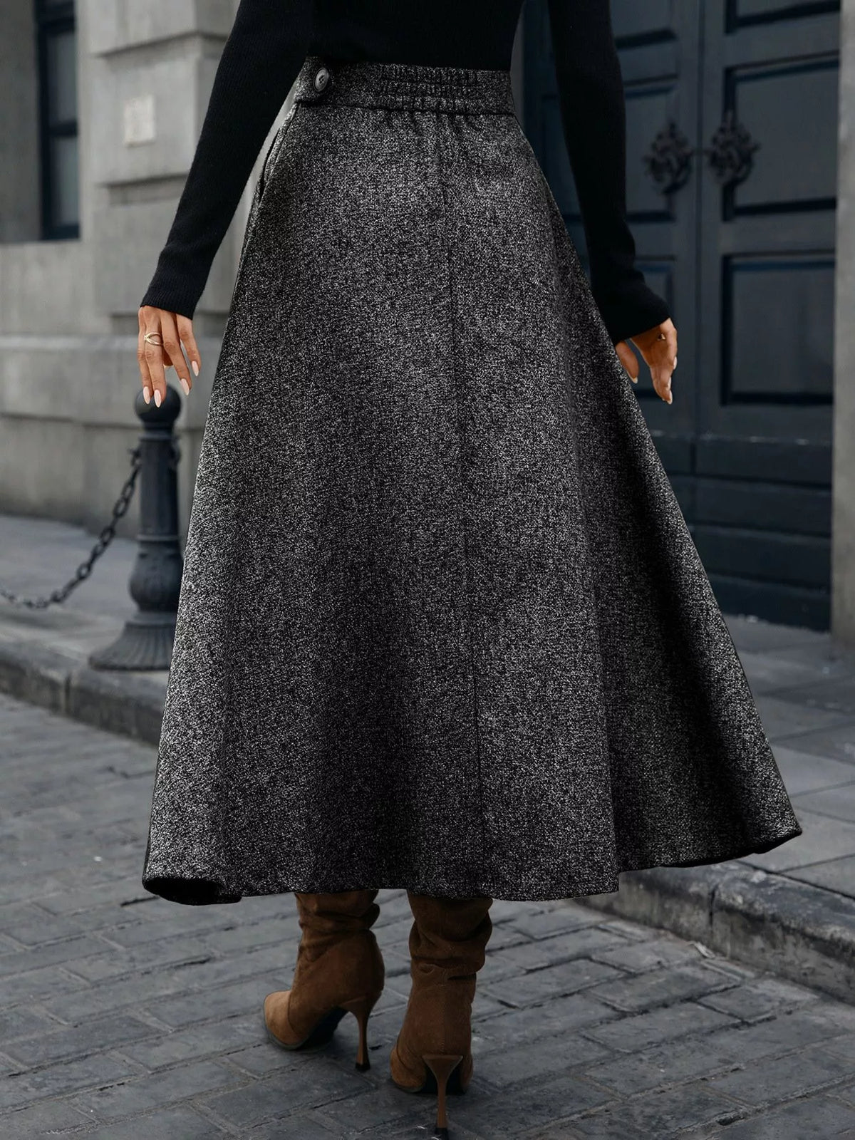 Back view of a gray A-line midi skirt with a buttoned waistband