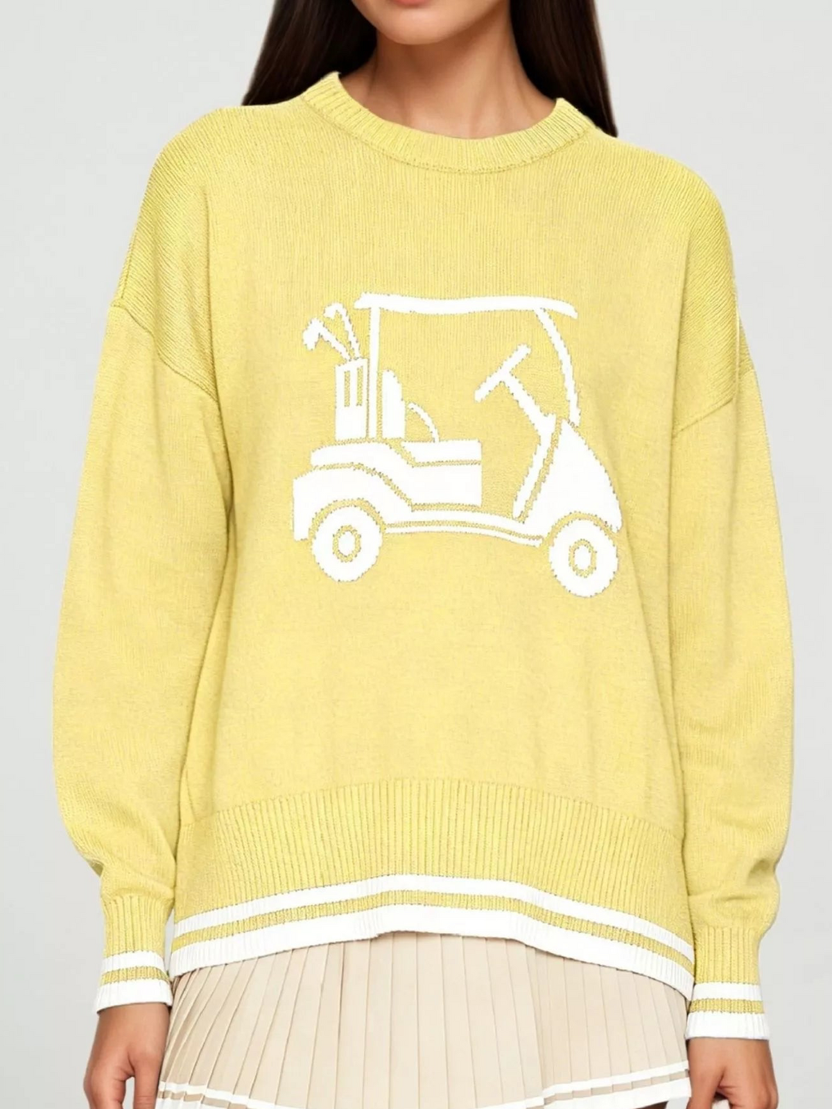 Yellow golf cart graphic sweater with ribbed cuffs, crew neck, and white striped hem