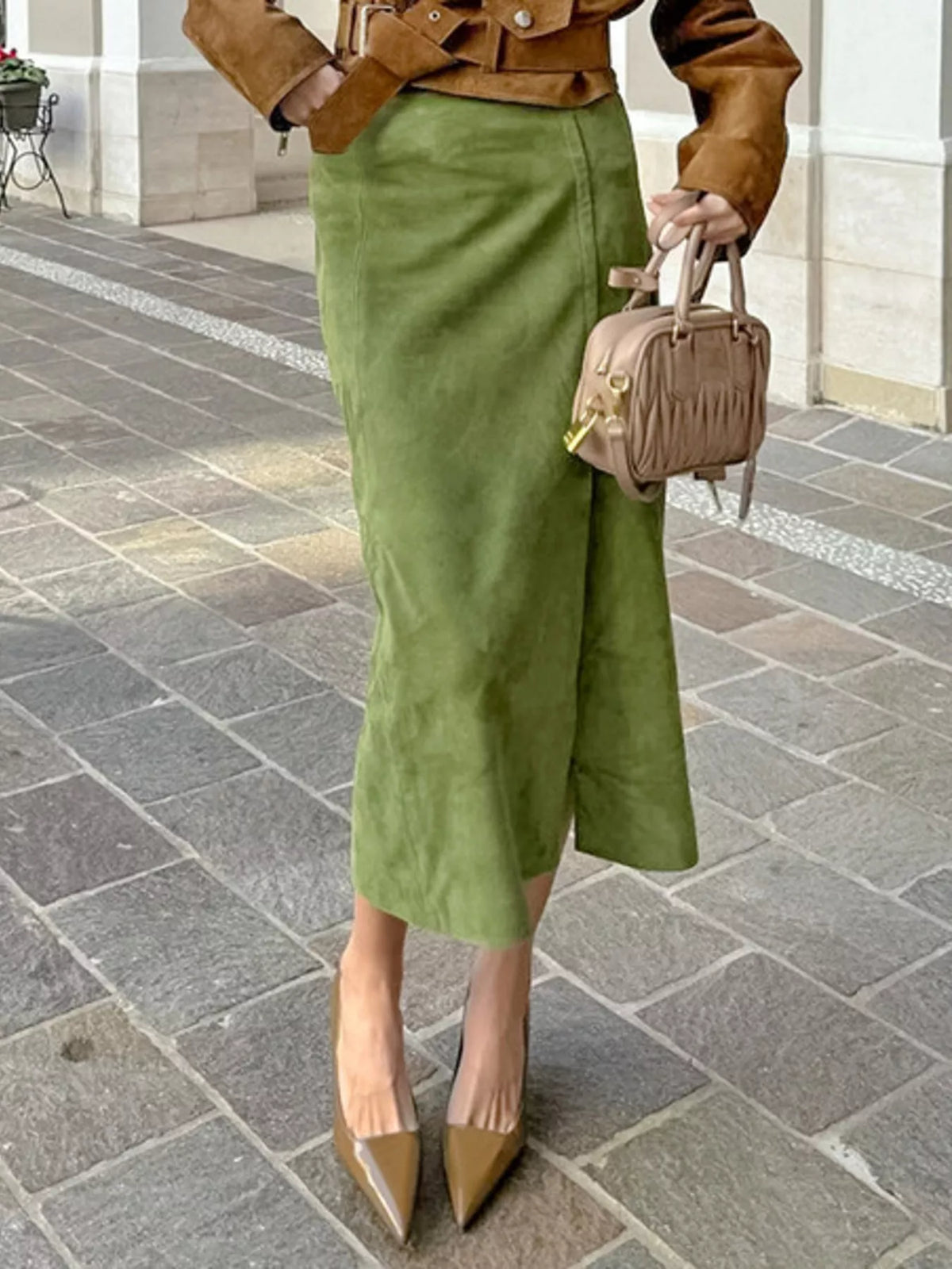 Matcha green midi skirt with a straight cut and side slit, styled with a cropped jacket.