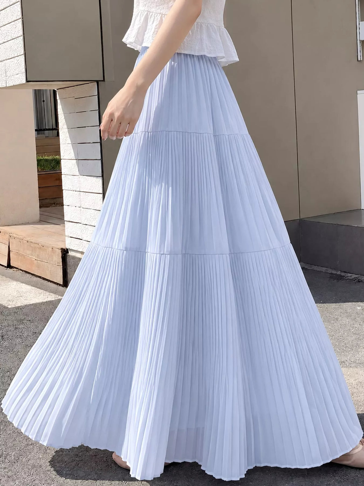 Light blue tiered pleated maxi skirt with elastic waist and full-length layered ruffles