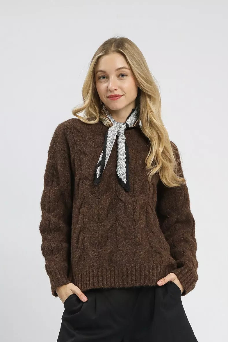 Brown cable-knit pullover sweater with long sleeves and gray patterned neck scarf
