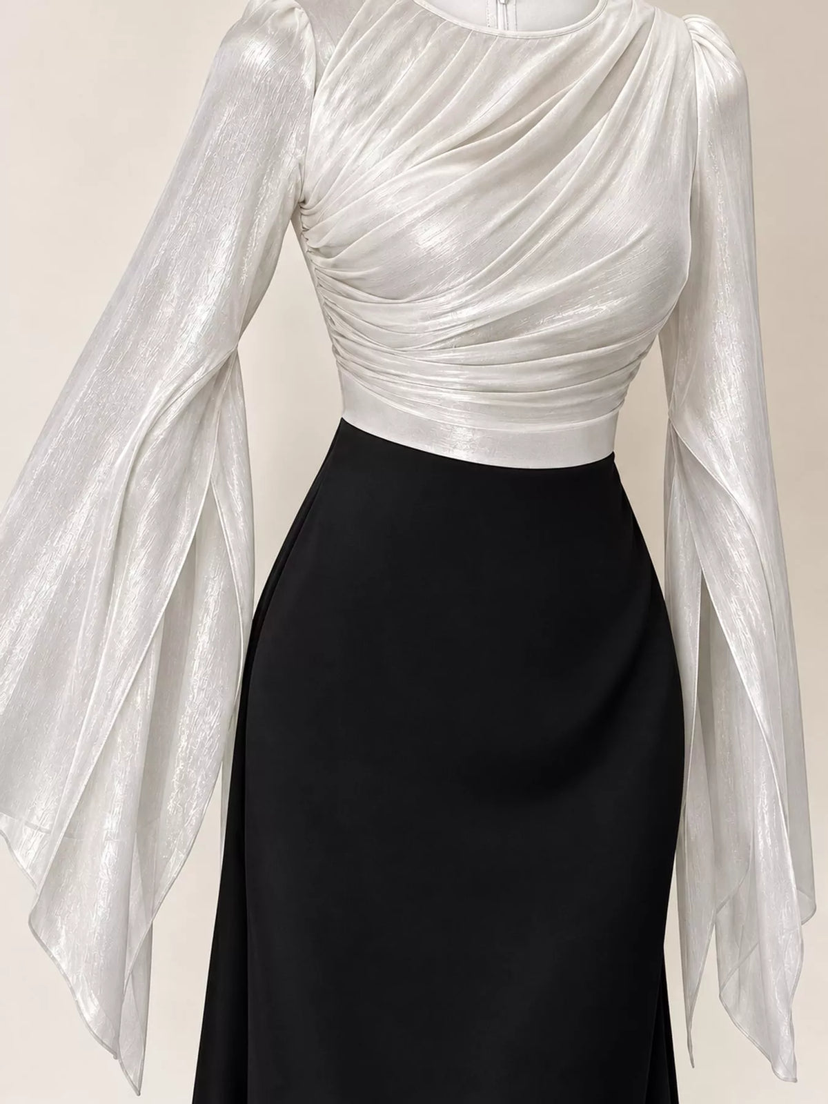 Colorblock maxi dress detail showing white ruched top and sheer sleeves with black skirt