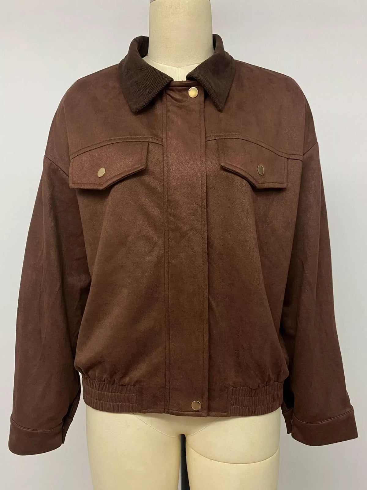Brown zip-up dropped-shoulder jacket on mannequin with snap flap chest pockets
