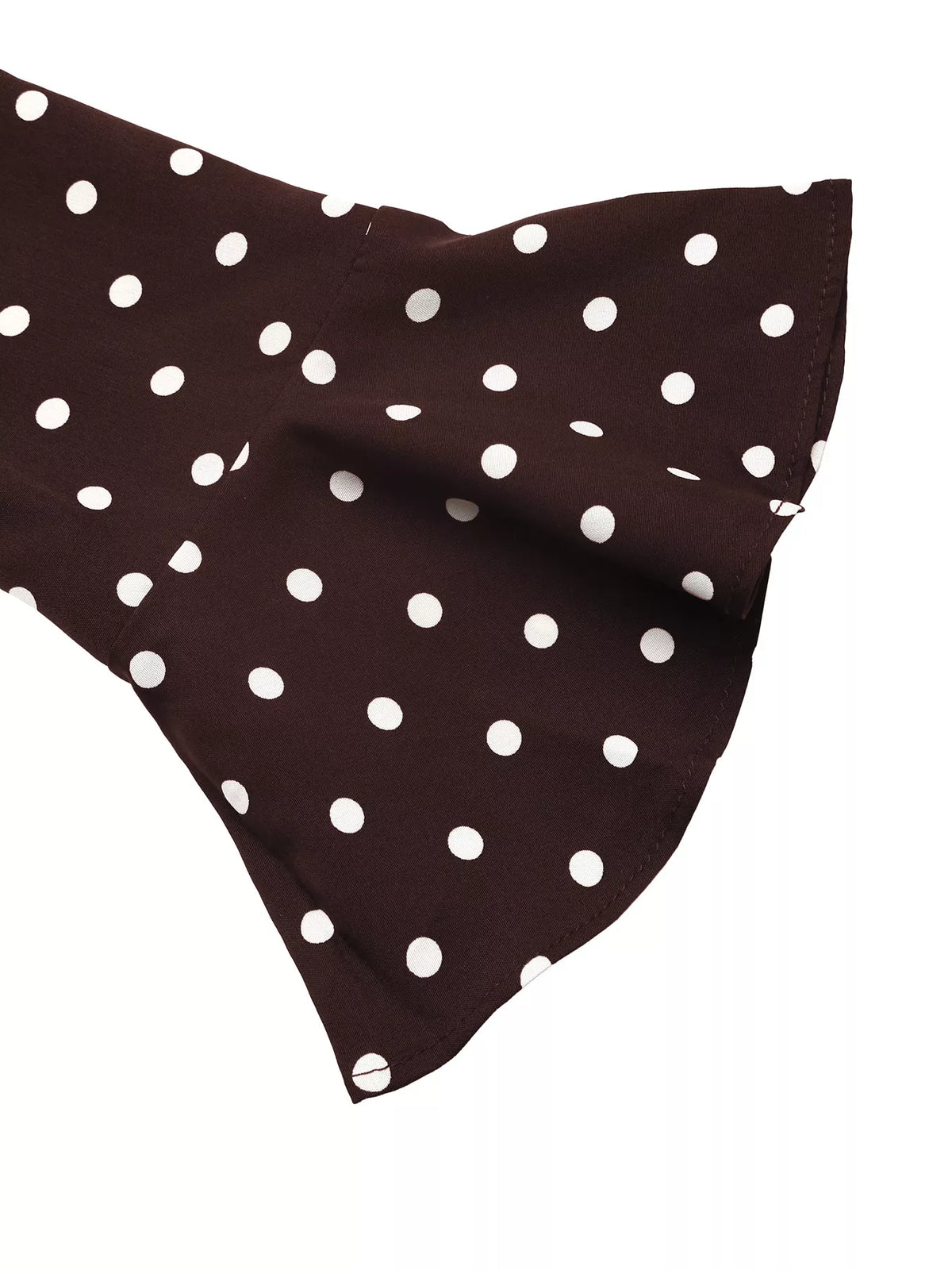 Detail of coffee brown polka dot sleeve cuff with flared, bell-like shape