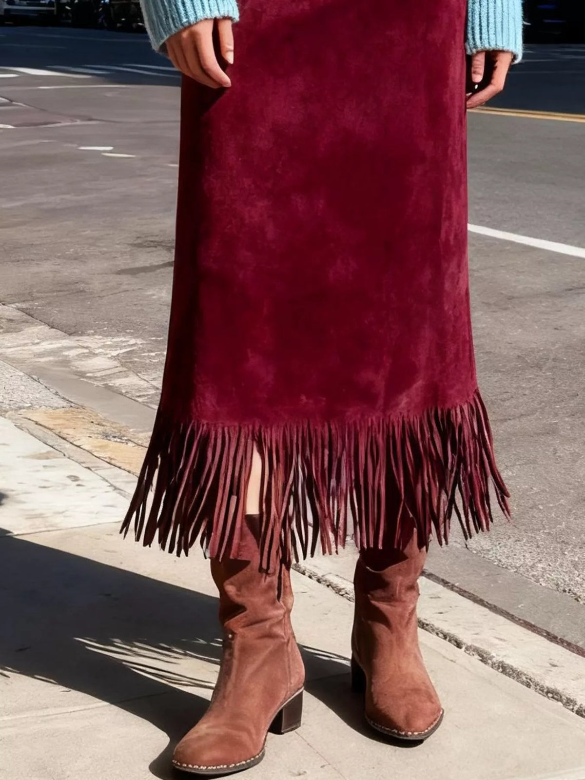 Deep red suede midi skirt with high waist and fringe along hem