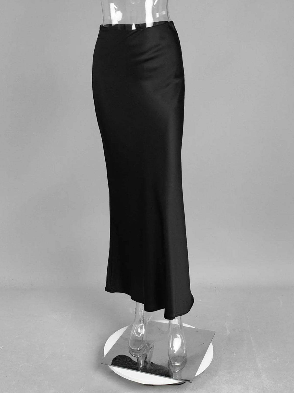 Black high-waisted maxi skirt on stand, straight cut with slight flare at hem