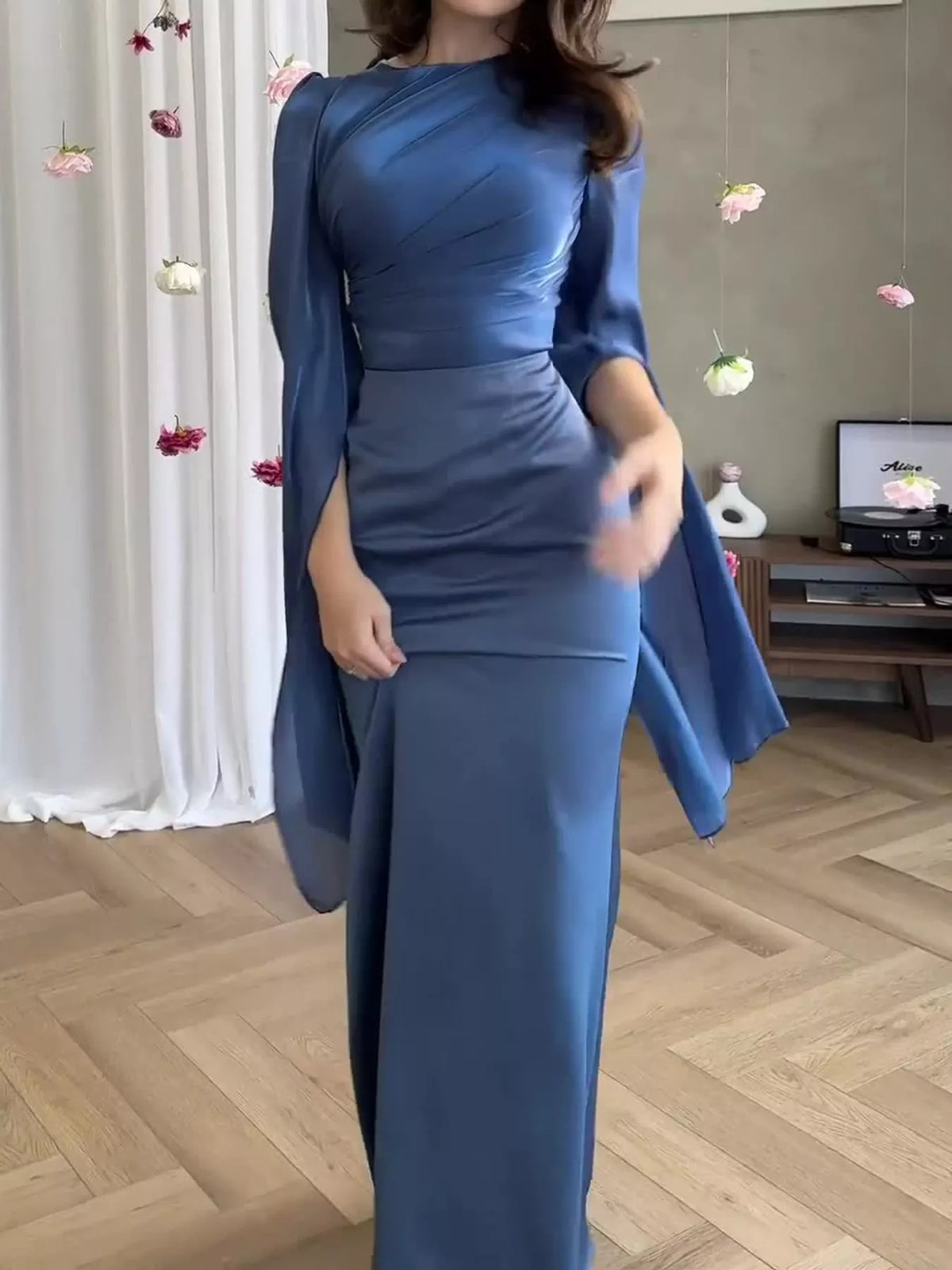 Blue floor-length dress with long flowing sheer sleeves and a ruched bodice