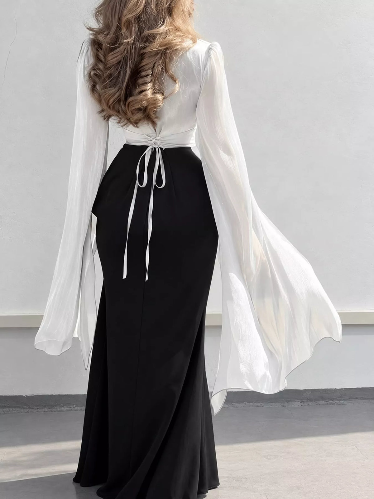Colorblock maxi dress with a white top, black skirt, back ties and sheer sleeves