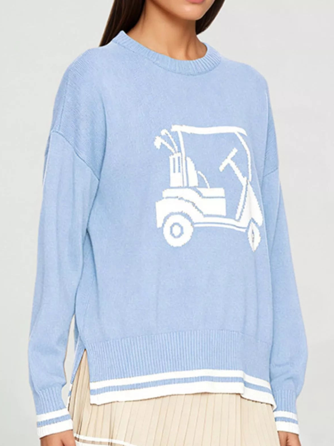 Light blue golf cart graphic sweater with ribbed cuffs, crew neck, and white striped hem