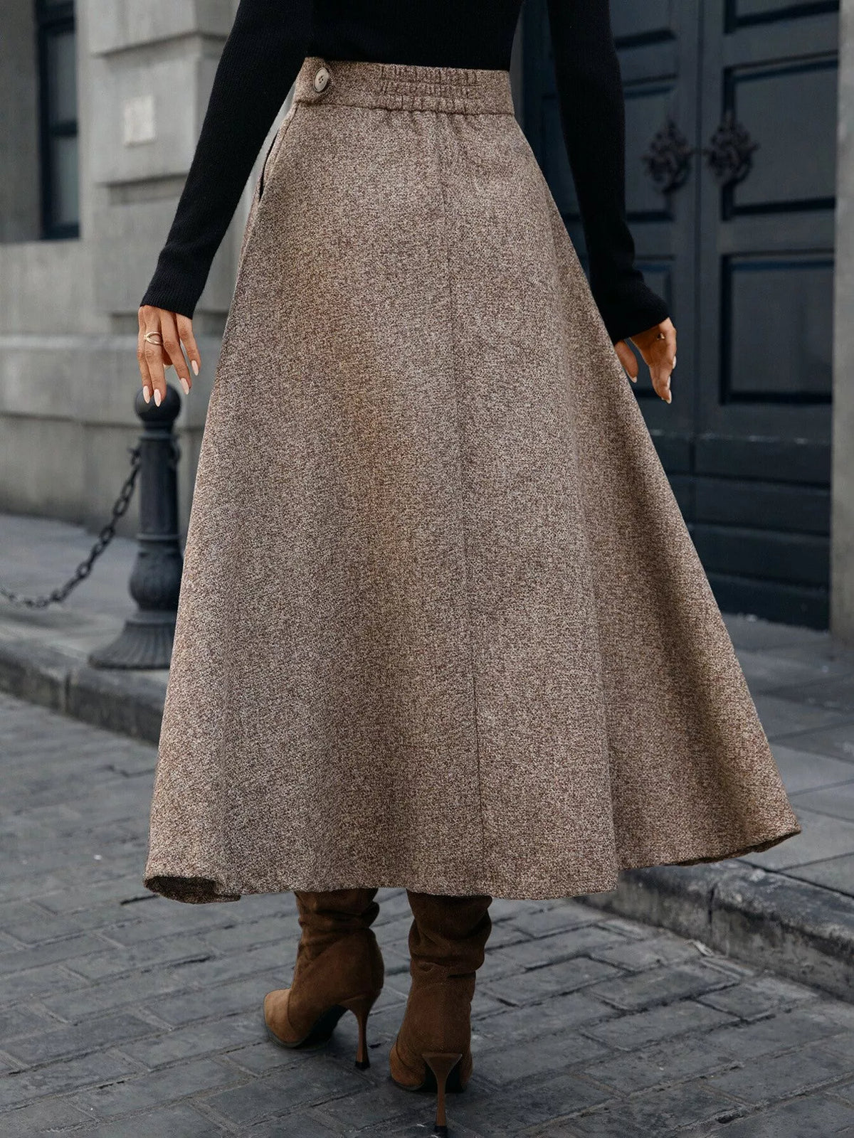 Back view of brown A-line midi skirt with a side button and full hem