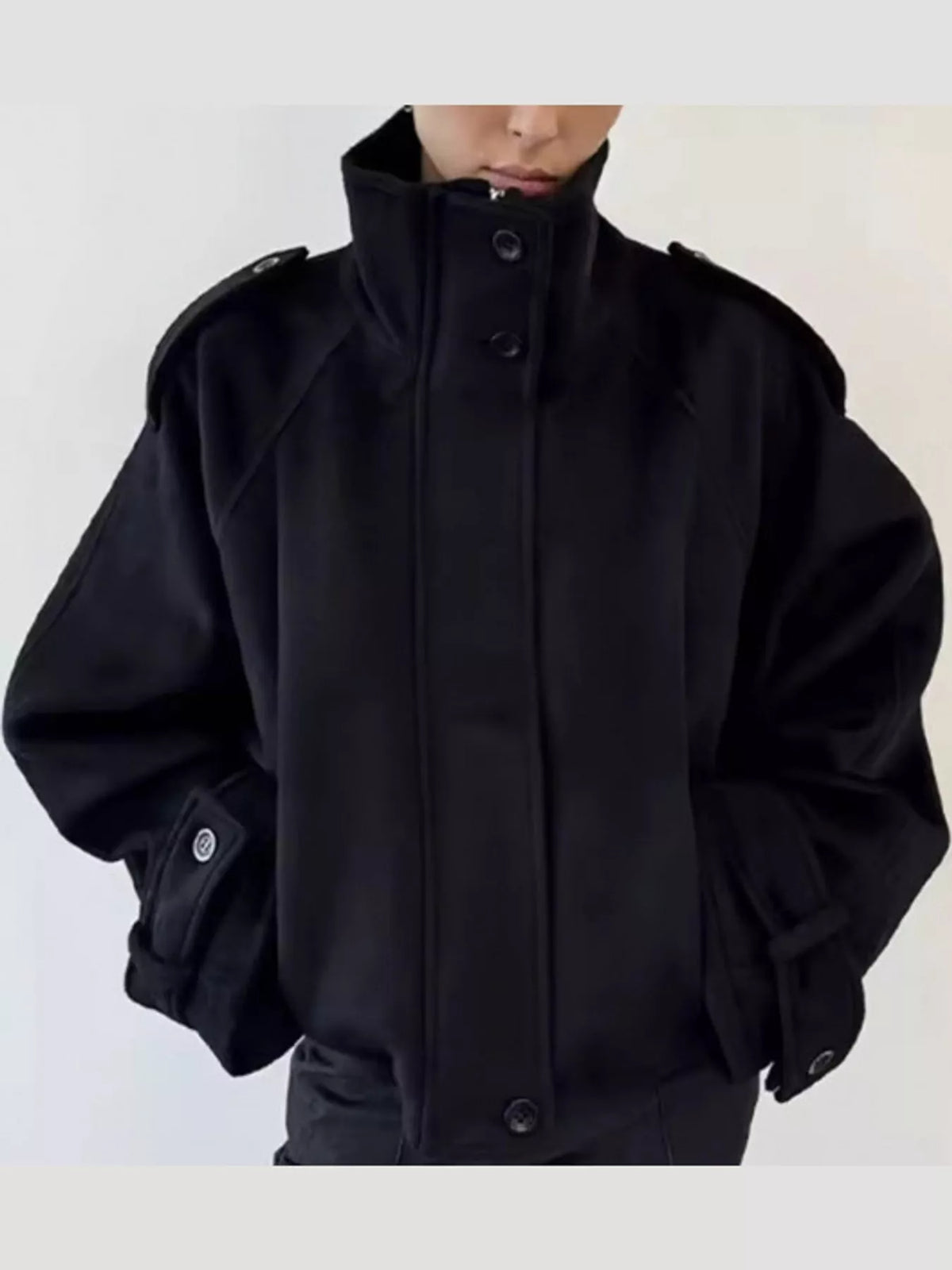 Black stand-collar zip-up jacket with snap buttons at the placket and cuffs.