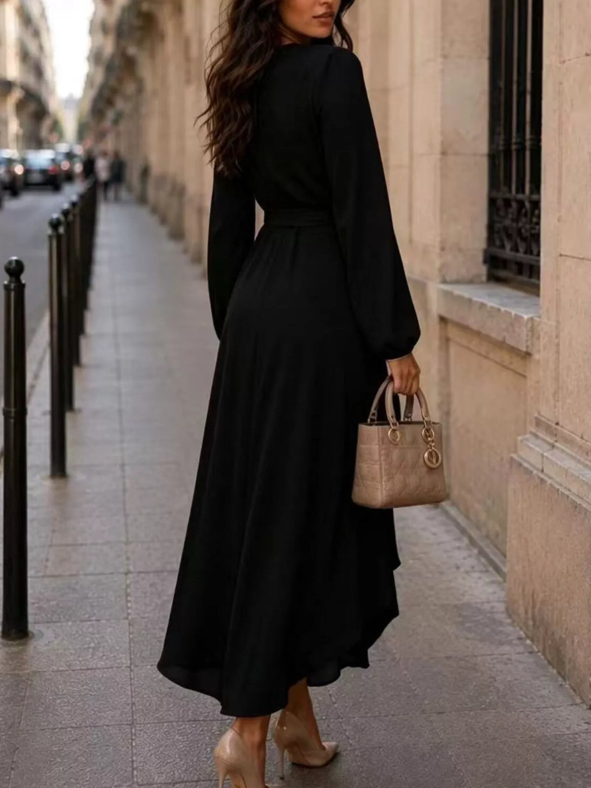 Black wrap midi dress with long balloon sleeves and waist tie, front view.