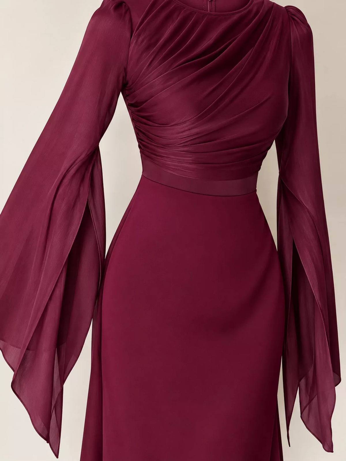 Burgundy dress detail showing a ruched bodice and long split sleeves