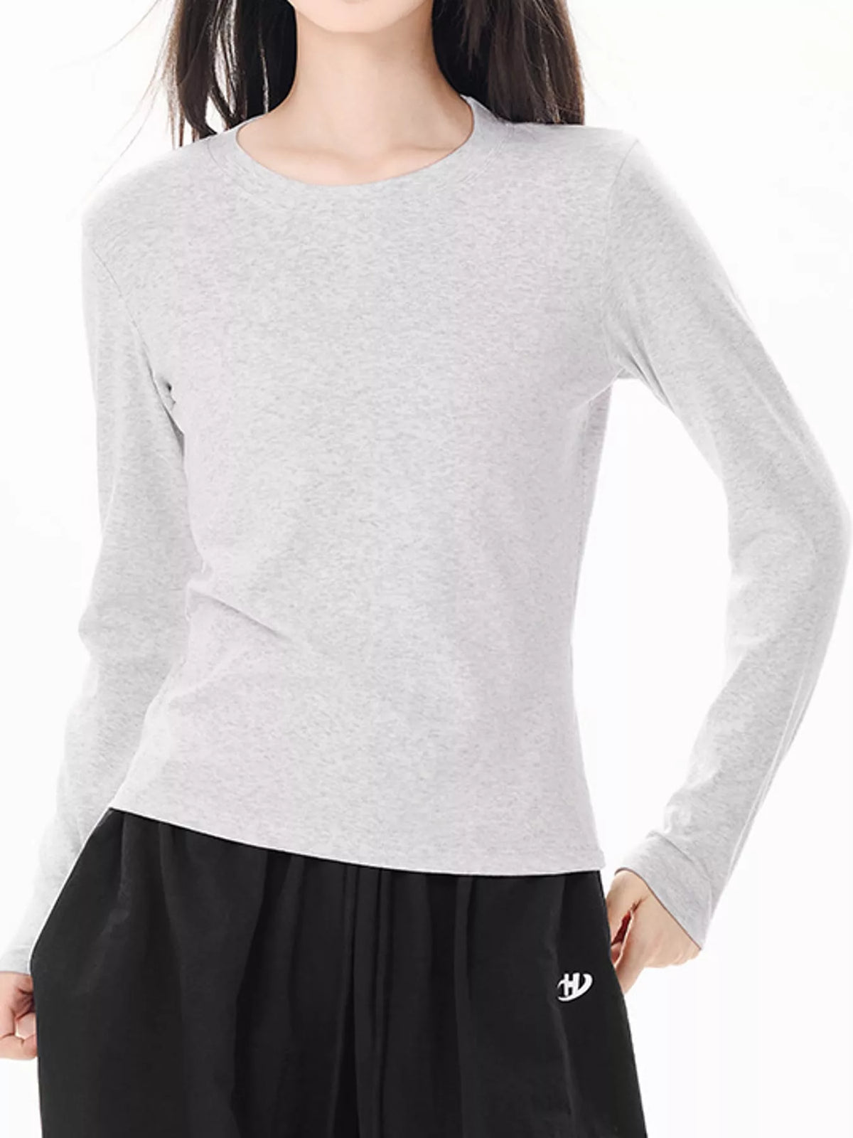 Light heather gray slim-fit long sleeve crew neck T-shirt on model.