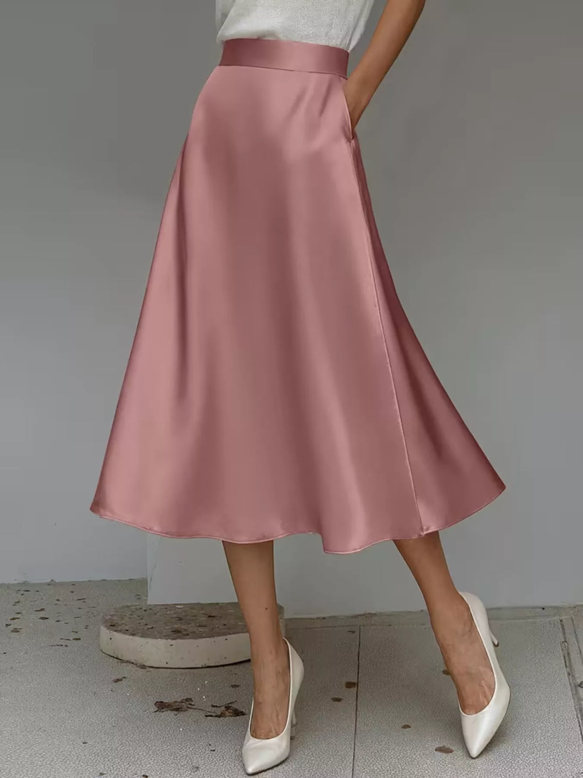 Pink satin midi skirt with a high waist and flowing flared hem