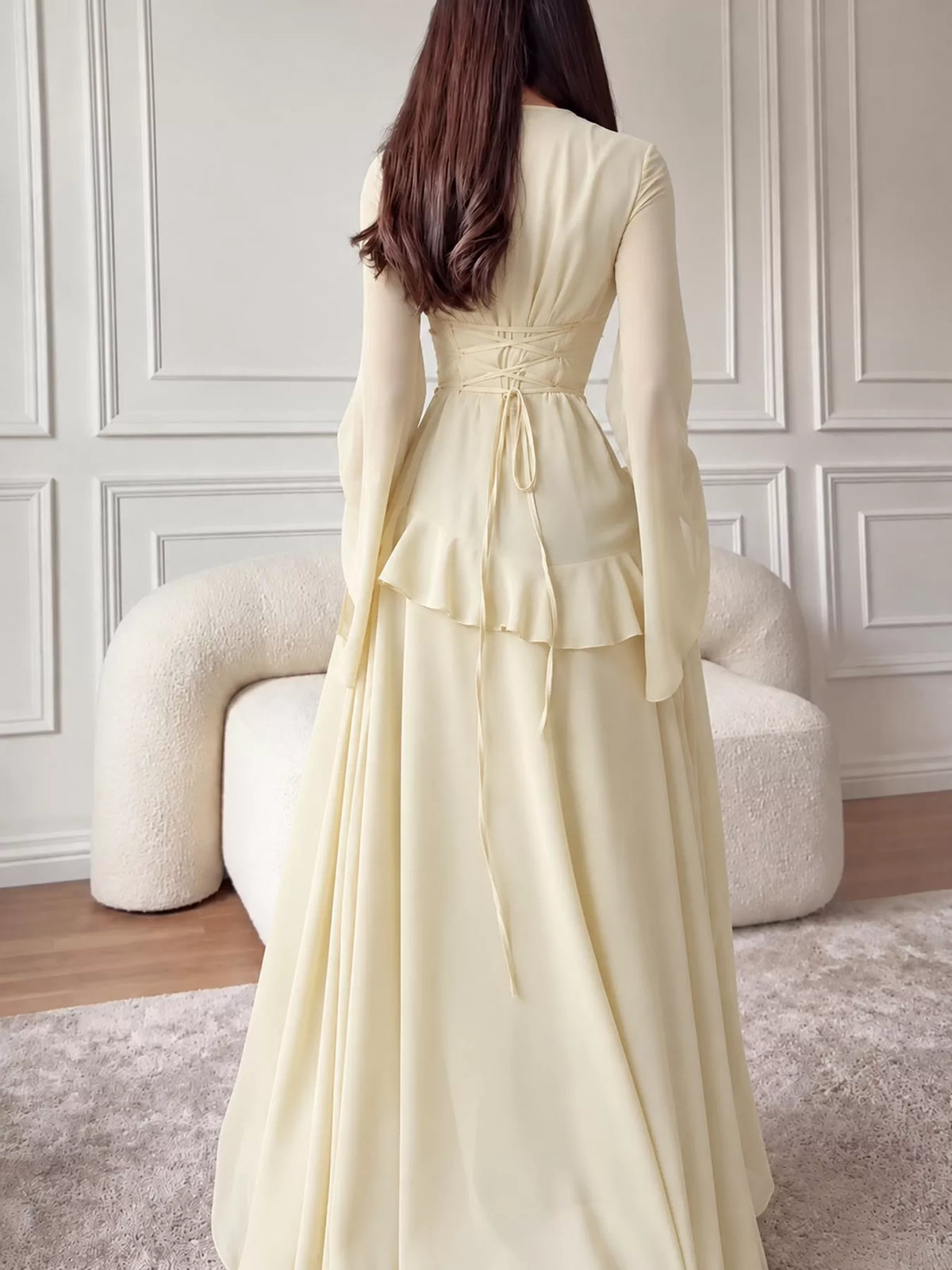 Cream maxi dress with tiered ruffle detail at sleeves and flowing gathered skirt