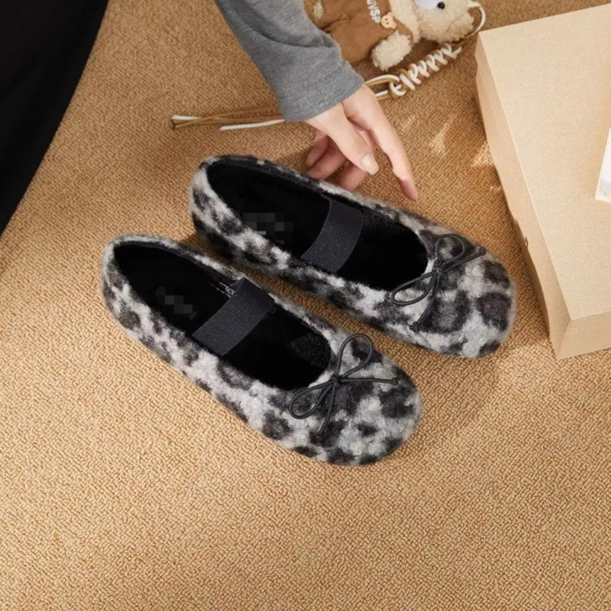 Faux fur leopard print slip-on shoes with black bands and bow laces